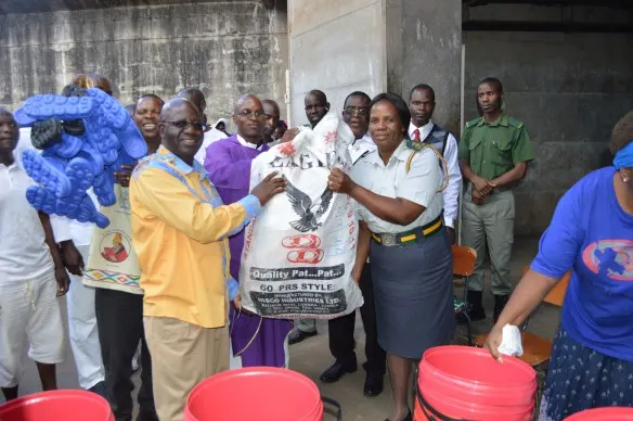 Fr. Kunaka hands over a bag of slippers to Mrs. Mutasa..JPG