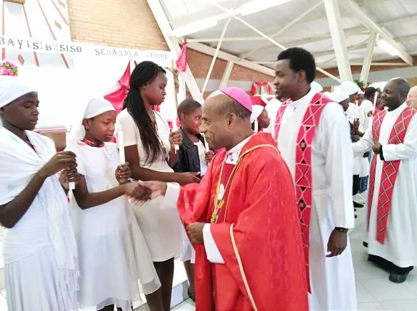 Archbishop Alex Thomas congratulates parishioners after confirmation..jpg