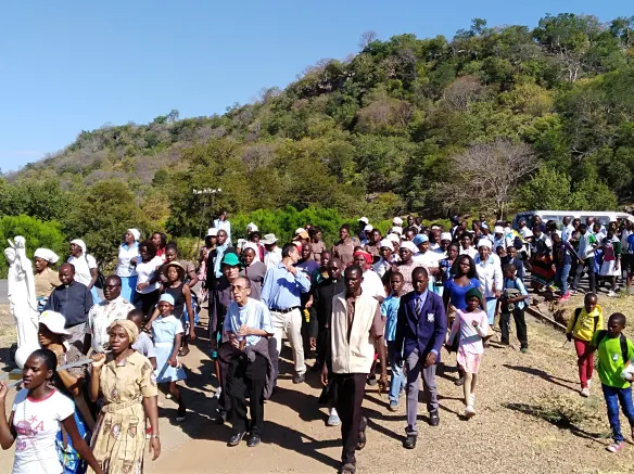 Bishop Albert Serrano is seen matching with pilgrims to St. Mary's Shrine in Lukosi..jpg