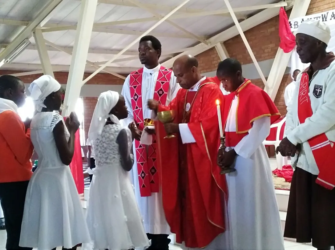 Catechumens receive holy communion from Archbishop Alex..jpg