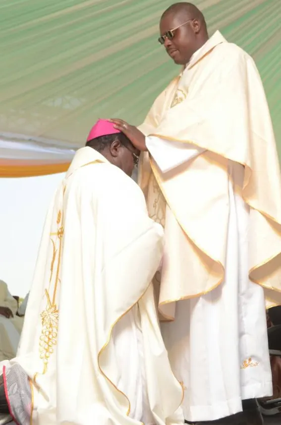 The newly ordained Fr. Wunganai blesses Bishop Michael Bhasera at St. Martin Deporres Mission in Zhombe.