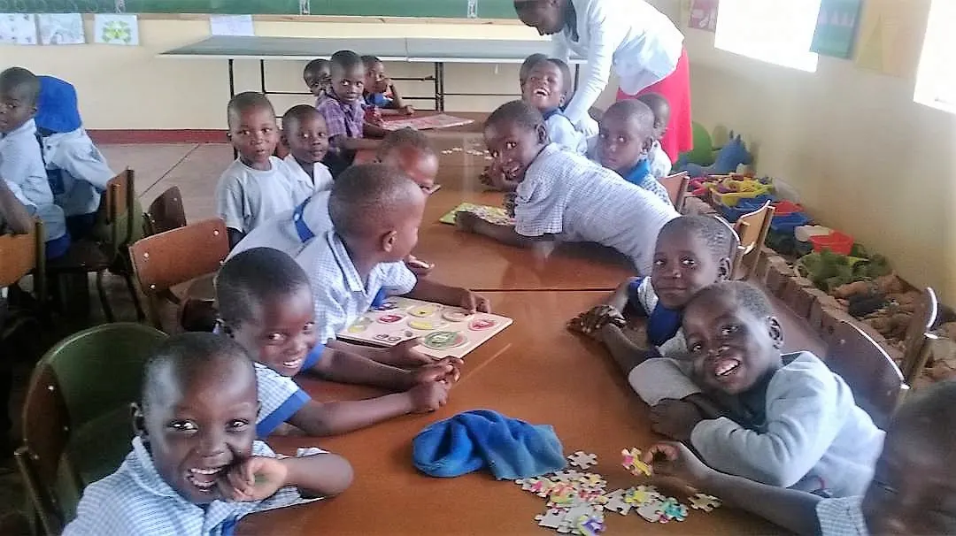 Learners at St. Claret share a smile during a photo shoot.