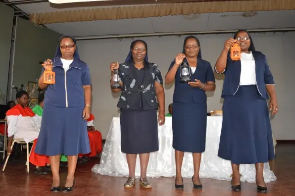The Sisters hold lambs that symoblise the life of Nano Nagle, foundress of their congregation.