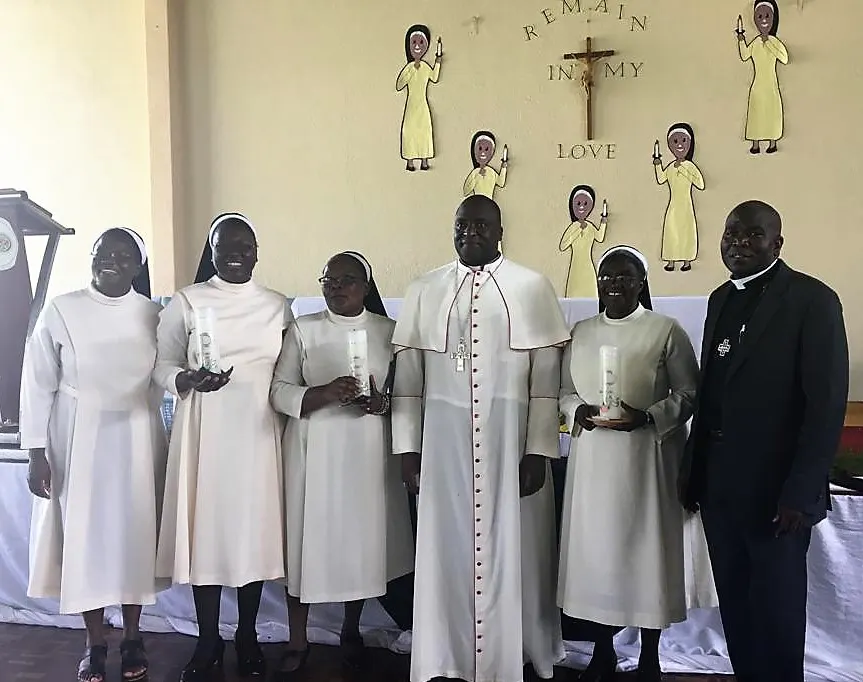 Bishop Raymond Mupandasekwa (middle) and Fr. Chota pose for a picture with three of the jubilarians.
