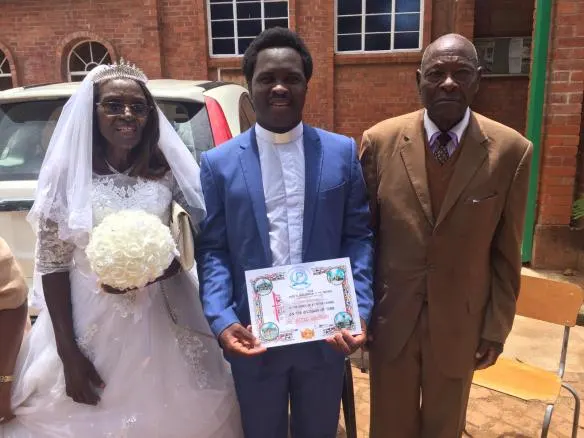 Fr. Claud Maganga (middle) pose for a picture with Mr. and Mrs Savanhu.