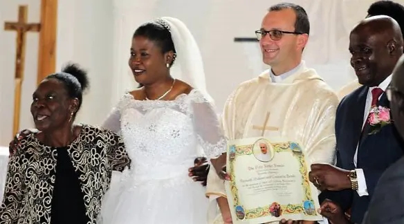 Mosingnor Gabriele Pesche (middle) pose for a picture with Mr. and Mrs. Mekani who received the Papal blessing at their 25th wedding anniversary.