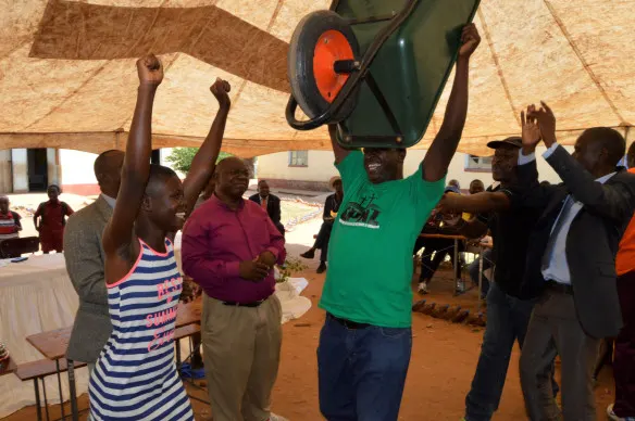 Teachers and students from Taringana High school rejoice after winning a wheelbarrow for their outstanding performance at the fun-run.