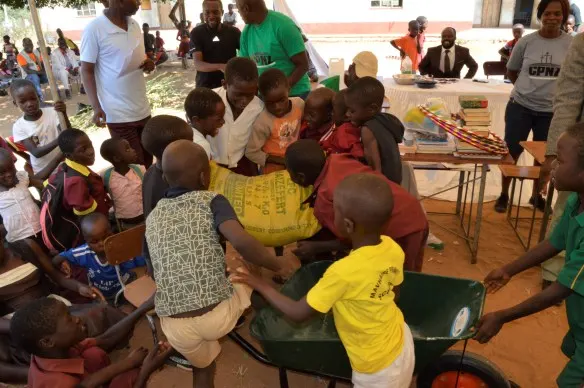 Mavhaire Primary School children carry a bag of fertilizer that the school won.