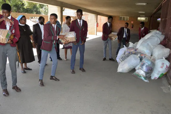 Prince Edward High School Club offloads donated items destined for St. Charles Luanga that was hit by Cyclone Idai.