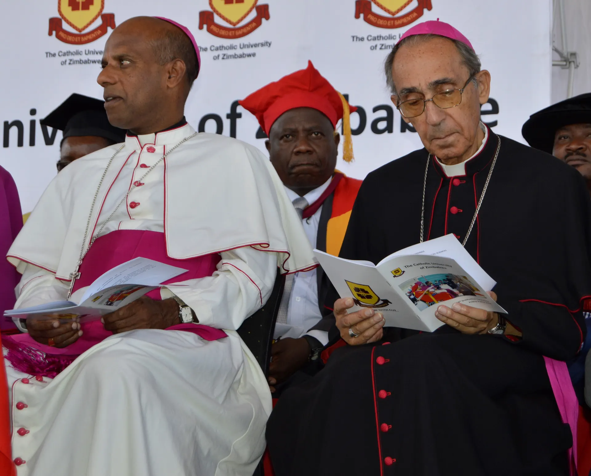 Archbishop Alex Thomas and Bishop Albert Serrano follow proceedings at the CUZ 16th graduation.