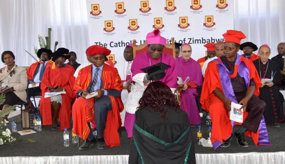 Archbishop Ndlovu caps one of the graduating students.