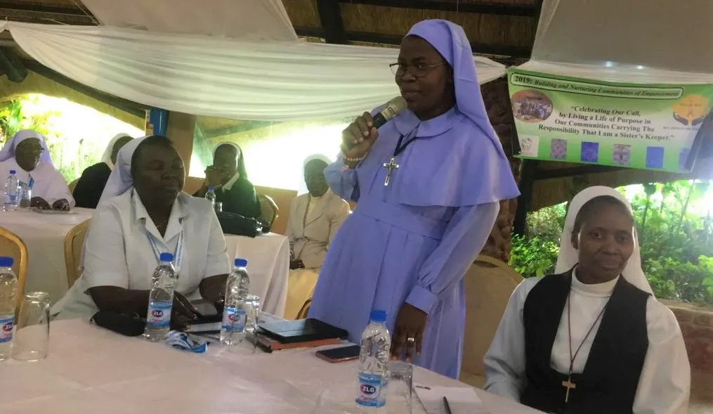 One of the visiting sisters asks a question during plenary.