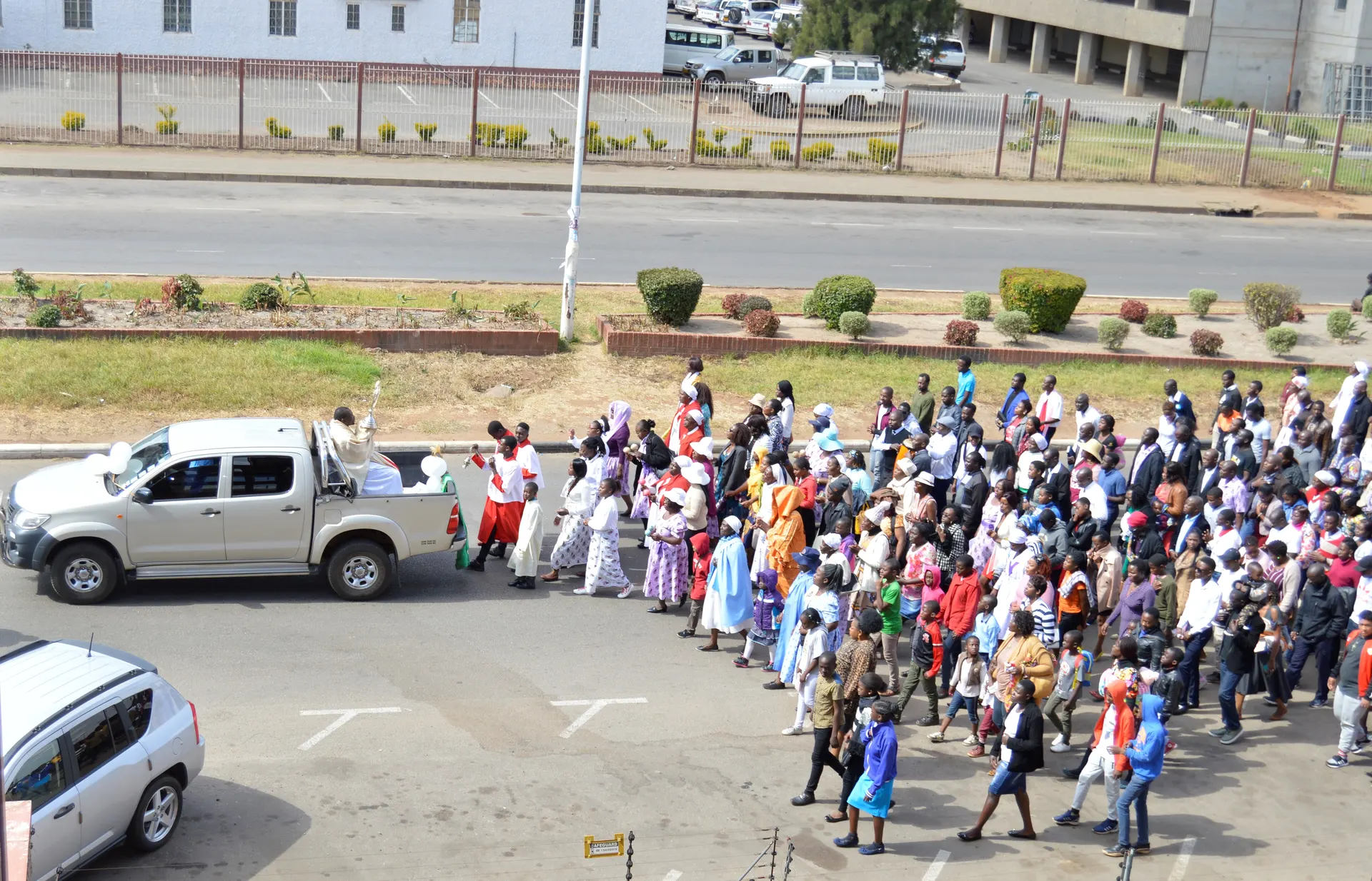 Fr. Kennedy Muguti lifts a monstrance with the blessed sacrament in a procession along Simon Muzenda Street in Harare.