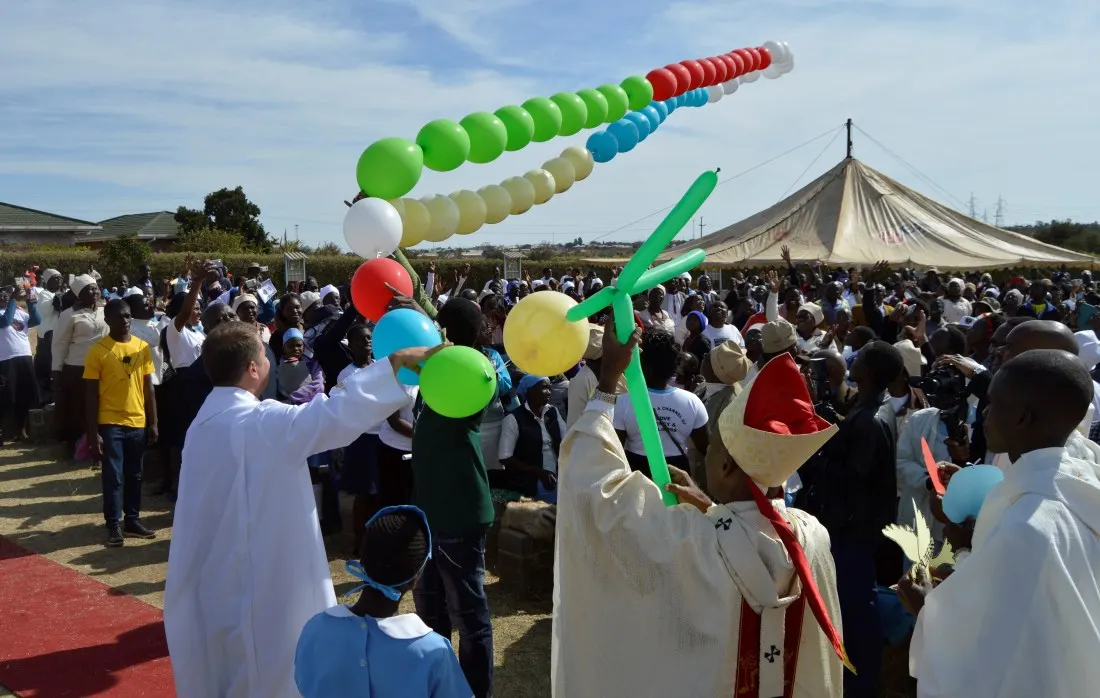 Archbishop Alex blesses the missionary rosay before releasing it into the air.